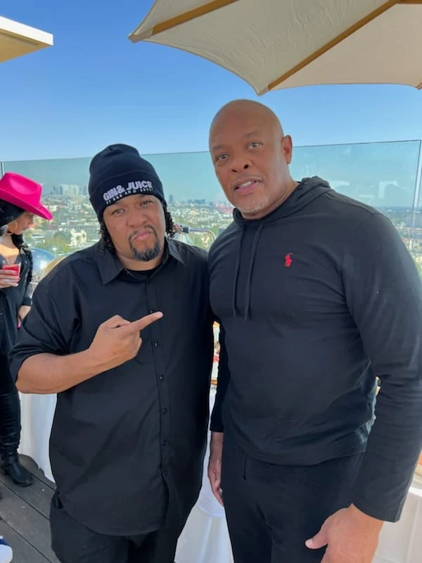 Frank “Nitty” Gibson Jr. with a friend at a rooftop industry event