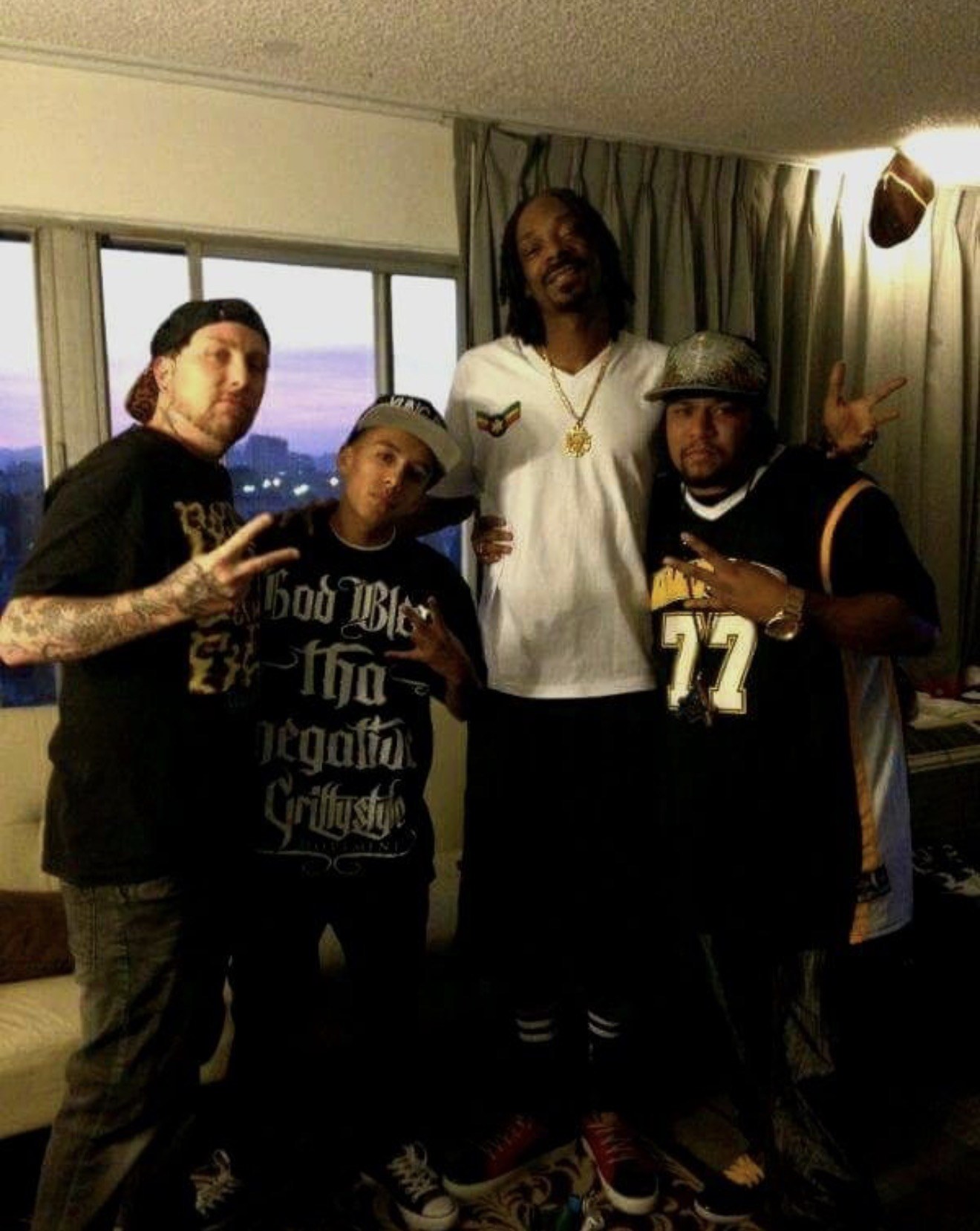 Frank “Nitty” Gibson Jr. with three others in a room at dusk